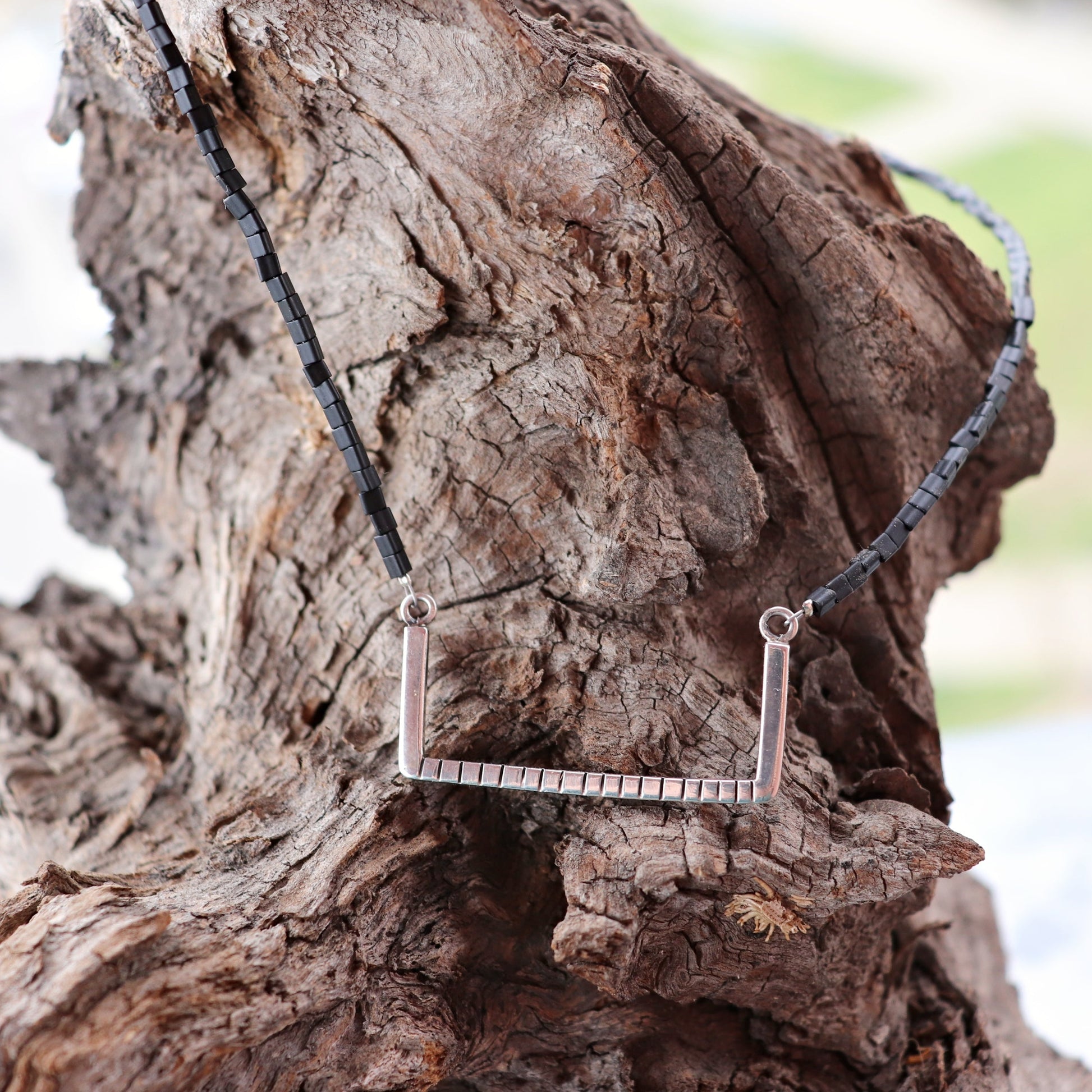 Handcrafted minimalist silver necklace "Between the Lines" with glass triangle beads, made from recycled silver. By ZiZou Nakit.