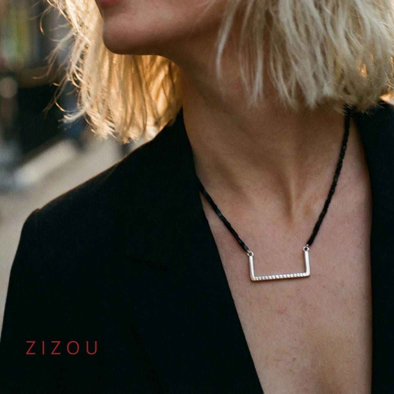 Handcrafted minimalist silver necklace "Between the Lines" with glass triangle beads, made from recycled silver. By ZiZou Nakit.